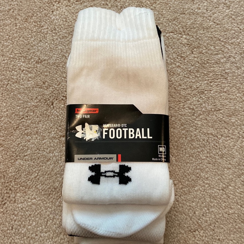 Two pair under armor, heat gear, football socks, NWT.